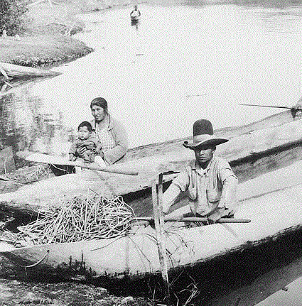 Klamath Indians in dugout canoes