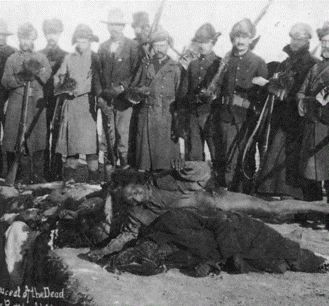 U.S. soldiers putting Indians in common grave after the massacre of Wounded Knee. Image: Library of Congress